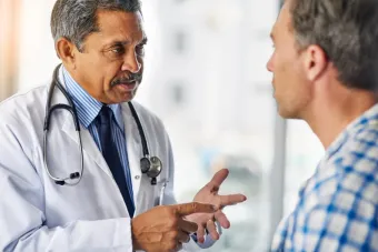 A male doctor speaking to a male patient.