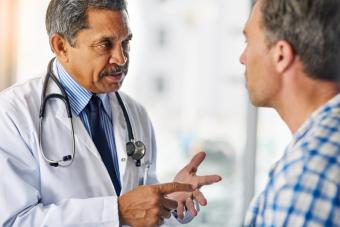 A male doctor speaking to a male patient.