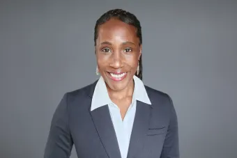 Headshot of Ashani Johnson-Turbes, Ph.D., Vice President and Director of the NORC Center for Equity Research. A Black woman with her hair pulled back wearing a dark gray blazer and white collared shirt.