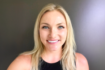 Headshot of Karly Quaack, Ph.D., a young, white woman with long blonde hair wearing a black tank top and smiling at the camera.