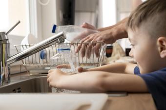 kid getting water from sink