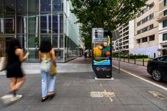turn to campaign materials displayed on busy street