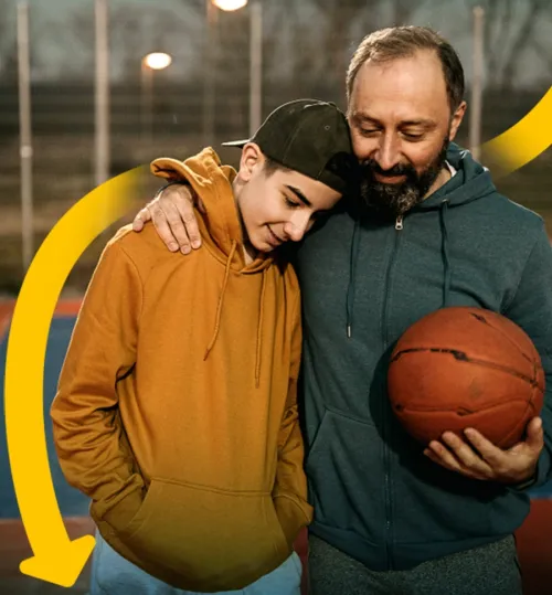 father and son hugging after playing basketball