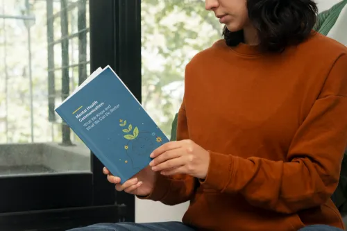 woman reading white paper on mental health communication 