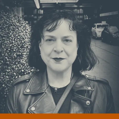 Headshot of Elizabeth Richmond-Garza, Ph.D., a white person (she/they) with chin-length black hair wearing a black shirt and black leather jacket looking at the camera.