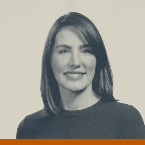 Headshot of Christina Thompson, a white woman with shoulder-length hair wearing a dark colored sweater and smiling at the camera.