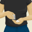 A person in a black shirt and blue pants pours three white pills from a small plastic bag into their hand.
